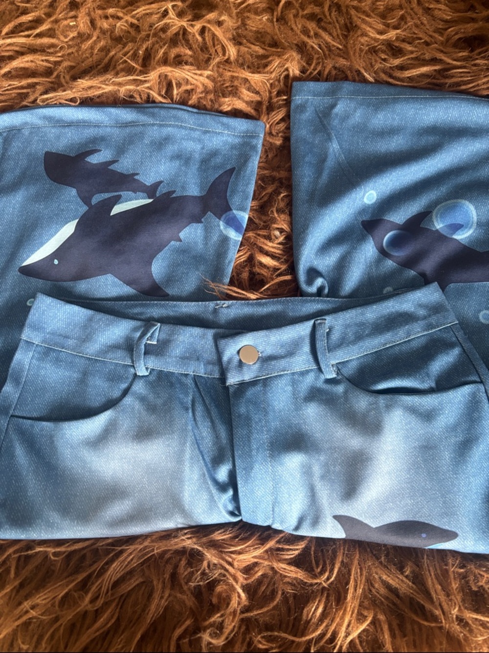 Love dolphins? Women’s Blue polyester bell bottom pants with dolphins on them.